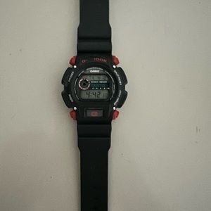 G Shock mens watch. Used but is in good condition. Black and red